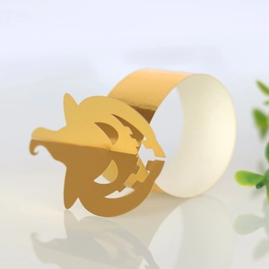 Detailed view of hollow-out gold pumpkin napkin ring for Halloween table decor