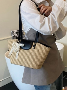 Handmade woven straw tote bag with black leather straps and pearl lace bow charm
