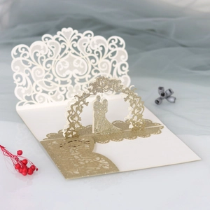 Macro detail of laser-cut wedding card featuring a 3D gold glitter silhouette arch