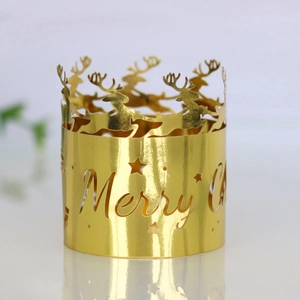 Close-up of golden Christmas candle holder with reindeer silhouettes and Merry Christmas cutout