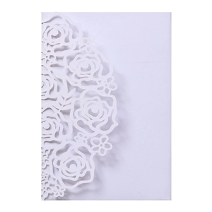 Detail of laser-cut rose floral pattern on high-quality white paper wedding invitation