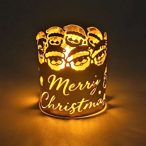 Detailed view of Merry Christmas hollow metal candle holder with Santa Claus silhouette