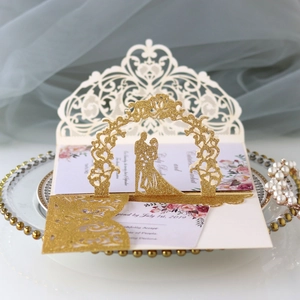 Detailed laser-cut wedding invitation with glitter gold arch and 3D couple silhouette