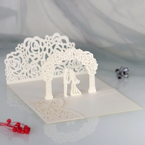 Detailed laser-cut 3D wedding invitation featuring a couple under a floral rose arch