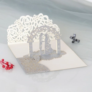 Detailed laser-cut 3D wedding card with silver glitter arch and couple silhouette