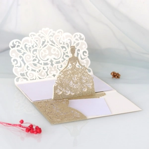 Macro shot of 3D laser-cut bride silhouette on a glitter champagne gold wedding card