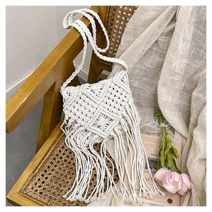 Detailed macro view of handmade macrame weaving patterns and soft cotton tassels