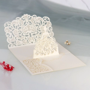 Close-up of laser-cut 3D princess wedding invitation with intricate lace floral patterns
