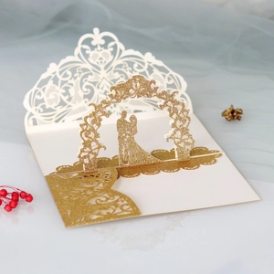 Detailed 3D pop-up wedding invitation featuring gold glitter laser cut floral arch and couple