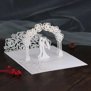 Detailed 3D laser cut wedding invitation showing a couple under a floral arch