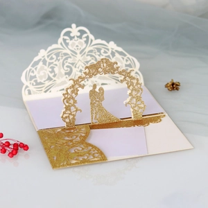 Detail of pop-up wedding card featuring laser-cut 3D gold floral arch and couple silhouette