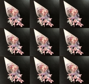 Detail of white laser-cut paper cones filled with dried hydrangea flower petals