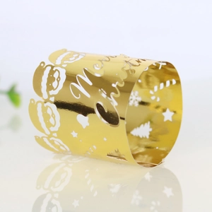 Detail of laser-cut gold Merry Christmas napkin ring with Santa and tree motifs