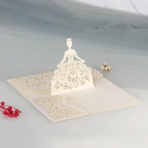 Macro view of 3D laser-cut cream wedding card with intricate lace bridal silhouette details