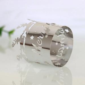 Macro shot of silver Merry Christmas napkin ring with reindeer and snowflake cutout