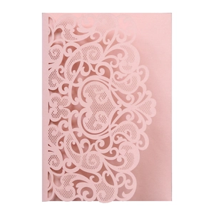 Macro view of pink pearlescent card with laser-cut floral patterns and intricate details