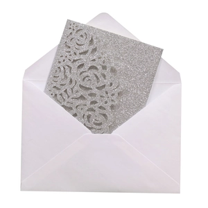 Close-up of glittery silver hollow rose invitation card with matching white envelope