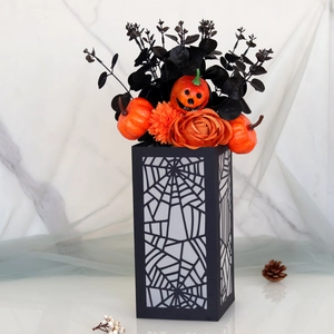 Macro detail of Halloween pumpkin floral arrangement with black spider web base