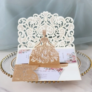 Detail of laser cut pop-up bride wedding invitation with champagne gold glitter finish
