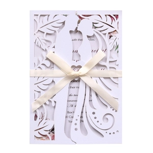 Laser cut wedding invitation with bride groom silhouette and cream ribbon bow detail