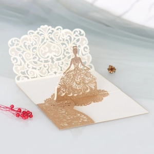 Detail of 3D laser-cut wedding invitation featuring a champagne gold glitter bride silhouette