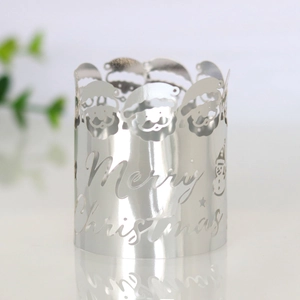 Macro shot of silver mirrored Merry Christmas candle ring with laser-cut metal patterns