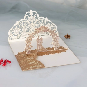 Detail of 3D pop-up wedding invitation featuring laser-cut gold glitter flower arch
