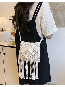 Handmade cream woven crossbody bag with geometric knit patterns and fringe tassels
