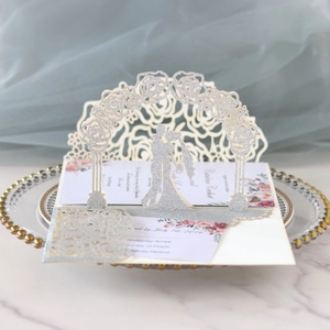 3D pop-up wedding invitation featuring laser-cut silver glitter rose arch and couple
