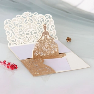 Detail of 3D laser-cut wedding invitation featuring a gold glitter girl silhouette