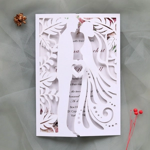 Macro detail of laser-cut wedding invitation featuring romantic couple silhouettes