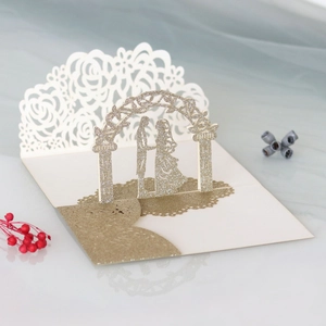 Detail of 3D pop-up wedding card with laser-cut gold glitter rose arch and ivory paper