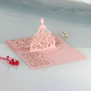 Detail of pink 3D laser-cut wedding card featuring an elegant lace dress girl design