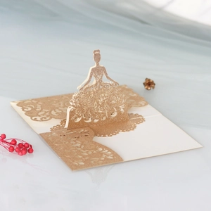 Detailed laser-cut 3D pop-up card featuring a golden glitter princess for wedding invitations