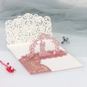 Detailed 3D laser-cut wedding invitation featuring a romantic couple under floral arch