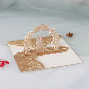 Detail view of 3D pop-up wedding invitation featuring gold glitter laser cut flower arch