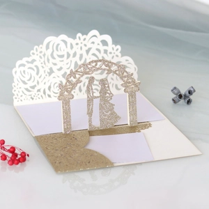 Detail of laser-cut rose border and gold glitter 3D arch on wedding invitation card