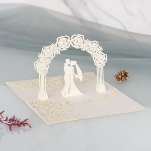 3D pop-up wedding invitation card featuring laser-cut floral arch and couple silhouette