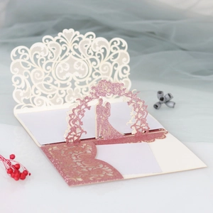 Detailed laser cut lace wedding invitation with romantic pop-up silhouette and gold glitter