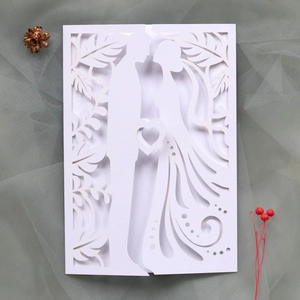 Detailed laser-cut wedding invitation featuring a romantic couple silhouette on premium paper