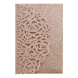 Close-up of laser-cut rose hollow pattern on rose gold glitter card for invitations