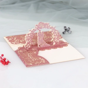 Detailed 3D laser-cut wedding invitation featuring rose gold glitter and couple silhouette
