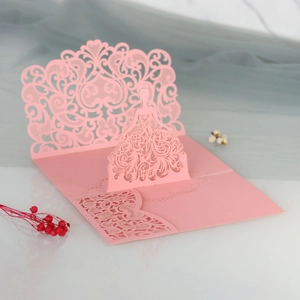 Detailed 45-degree macro view of pink laser-cut 3D lace floral wedding invitation card