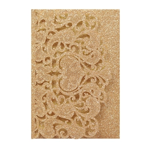 Intricate laser-cut gold glitter wedding invitation with heart and floral lace patterns