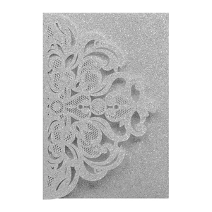 Detailed laser-cut silver glitter wedding invitation with elegant floral vine patterns