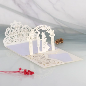 3D laser-cut wedding invitation featuring a romantic couple silhouette under floral arch
