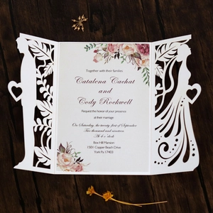 Laser-cut wedding invitation featuring white filigree silhouettes and lavender floral inserts