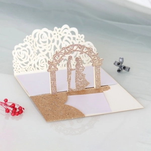 Detailed laser cut 3D pop up wedding card with champagne glitter arch and couple silhouette