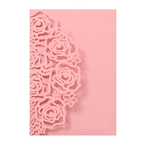 Close-up of pink laser-cut floral pattern with intricate rose details on wedding card