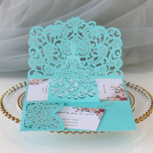 Detail of laser-cut wedding invitation featuring mint green lace and bride silhouette